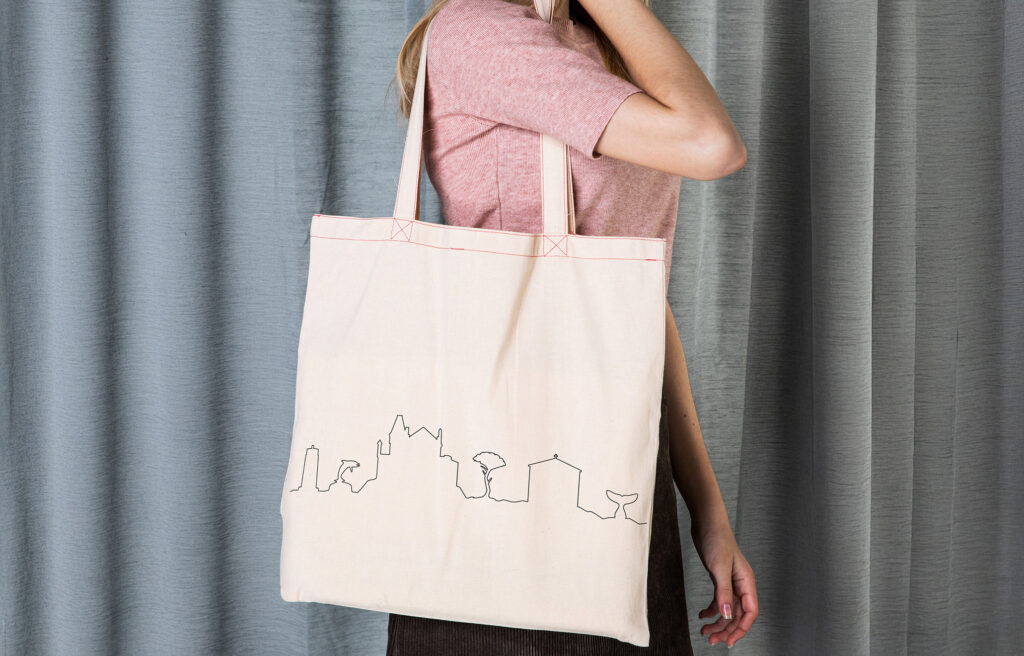 Tote bag beige avec marquage de la ligne graphique en noir de la skyline de Sausset les pins